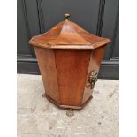 An antique mahogany coal box and cover, of tapered octagonal form, on brass paw feet, 42cm wide.