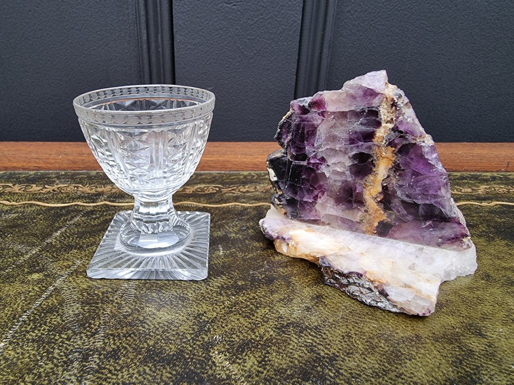 An unusual small 19th century cut glass pedestal egg cup, 6.3cm high; together with a Blue John