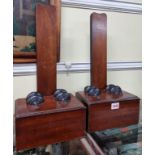 A pair of mahogany and ebonized plate stands, 44.5cm high.