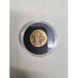 Coins: a George V 1917 gold sovereign, Melbourne mint.