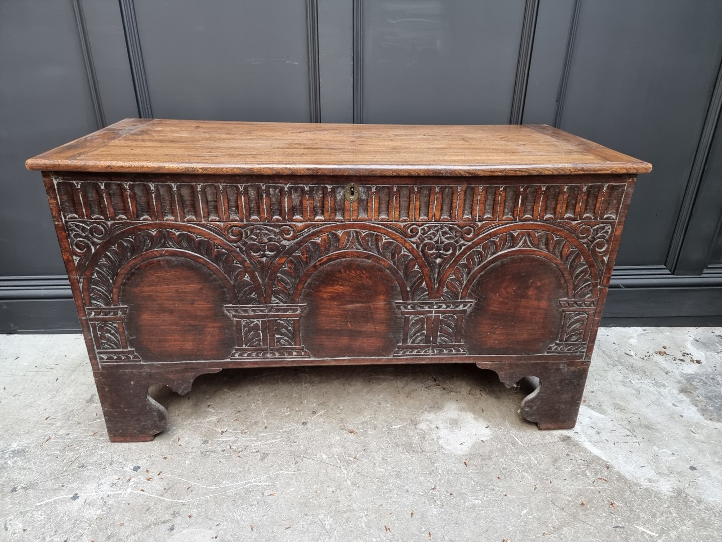 An early 18th century carved elm boarded coffer, 118.5cm wide.