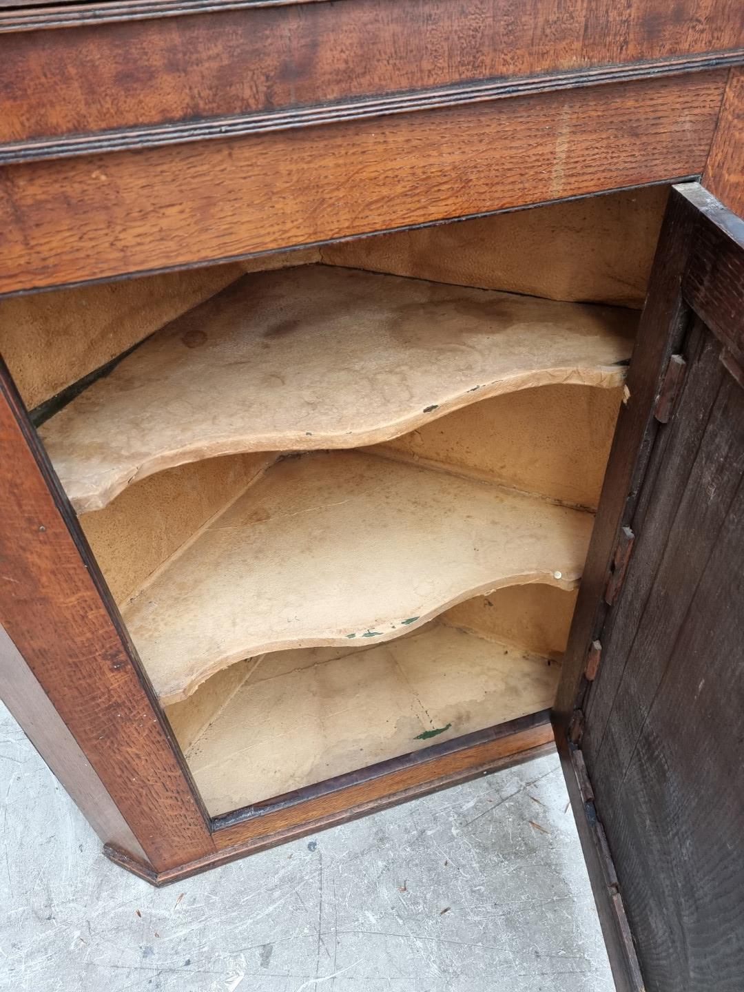 A George III oak and mahogany crossbanded hanging corner cupboard, 107.5cm high x 92cm wide; - Image 8 of 8