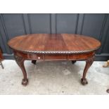 A late 19th/early 20th century carved mahogany extending dining table, 152cm extended, with