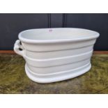 A Victorian white glazed pottery twin handled foot bath, 46.5cm wide.