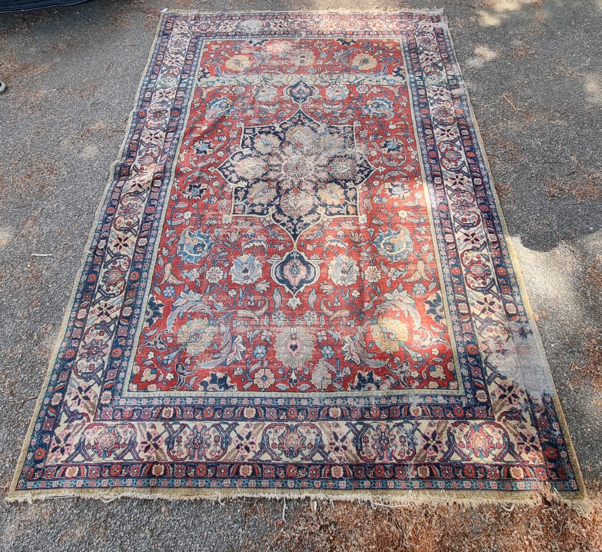 A Persian carpet, having central floral medallions, with floral cartouches to each corner of central