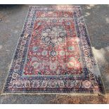 A Persian carpet, having central floral medallions, with floral cartouches to each corner of central