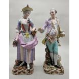 A large pair of Meissen porcelain figures of a gallant and companion, 50cm high, (some damage and