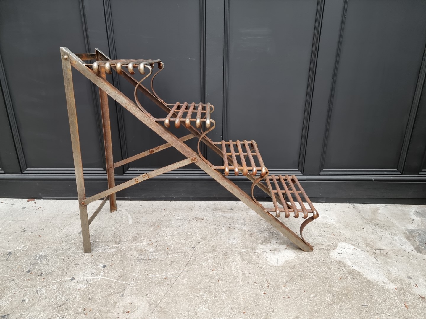 An Arras style steel plant stand, of ladder form, 88cm high x 107cm deep.