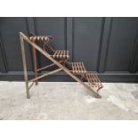 An Arras style steel plant stand, of ladder form, 88cm high x 107cm deep.