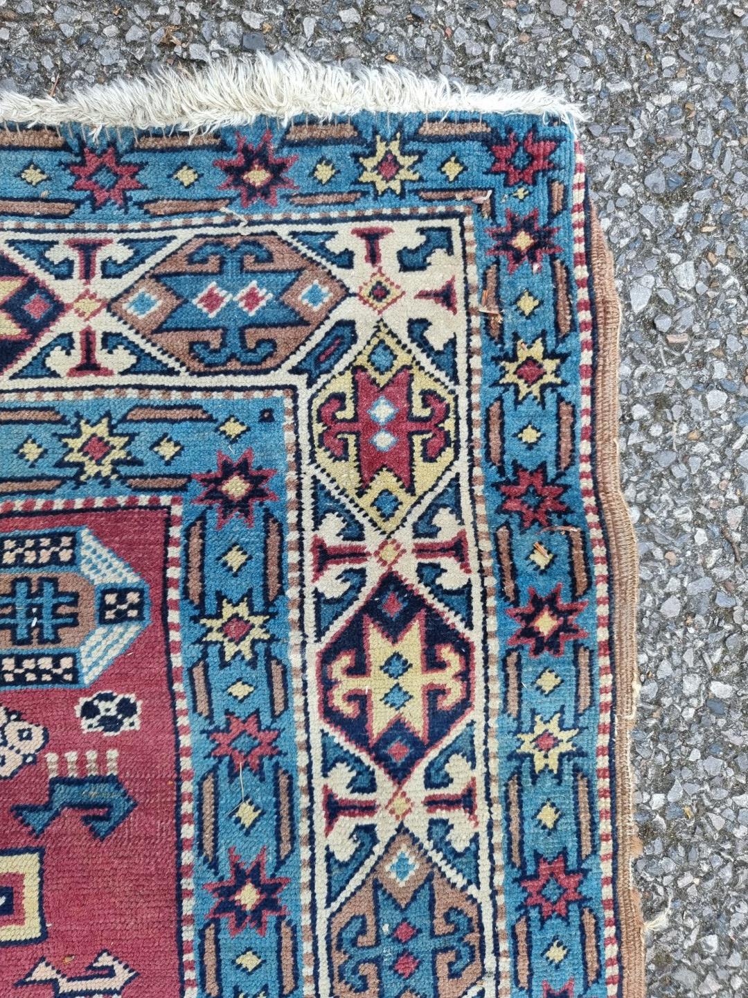 A Persian rug, having three central medallions, central field decorated with animals, with geometric - Image 5 of 5