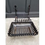 A cast iron fire grate, with small cast iron fireback.