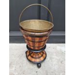 A 19th century Dutch fruitwood peat bucket, with brass liner and swing handle, total height 56cm.