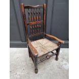 An unusually small 19th century ash and rush spindle back armchair.