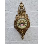 An antique brass wall clock, 57.5cm high.