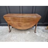 A George III mahogany drop leaf table, with ball and claw feet, 132cm wide.