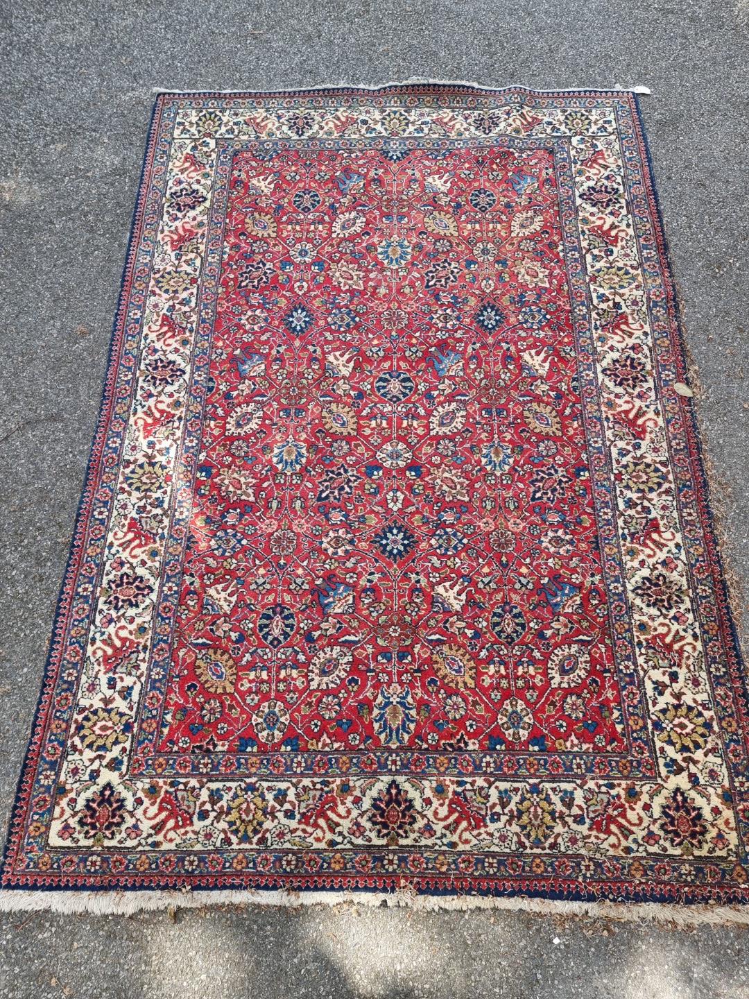 A Persian carpet, having allover floral decoration to central field, with floral borders, 295 x