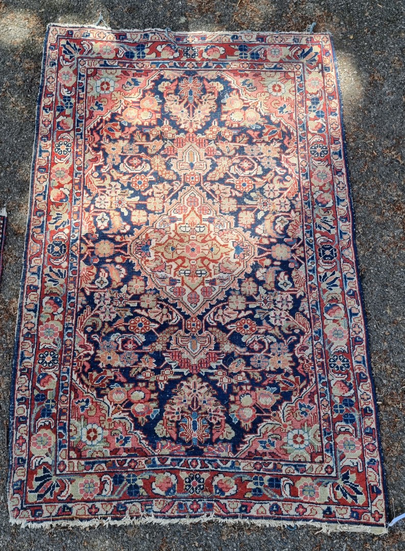 A Persian rug, having central floral medallion, with floral decoration to each corner, 199 x 131cm.