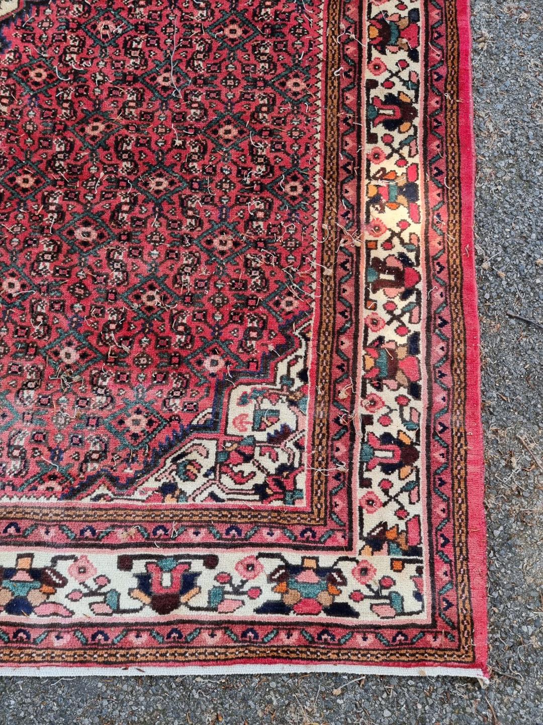 A Persian carpet, having central floral medallion, with floral decoration to central field, 392 x - Image 2 of 12