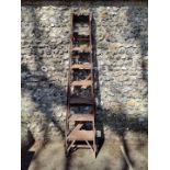 A large antique folding ladder.