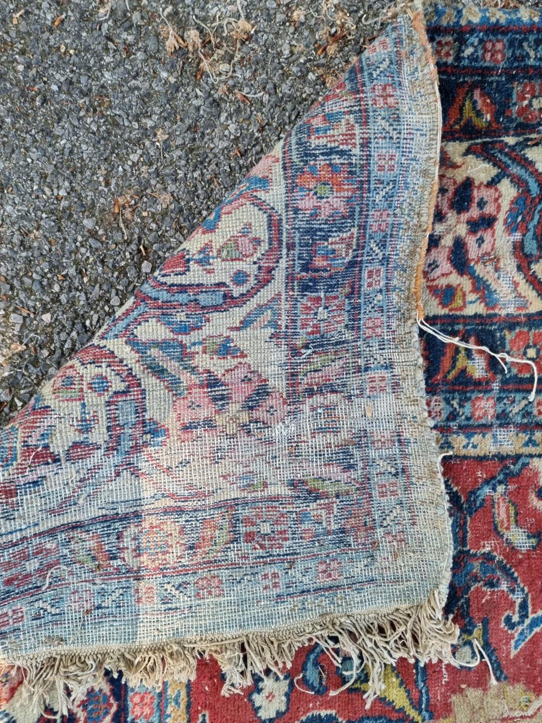 A Persian carpet, having central floral medallions, with floral cartouches to each corner of central - Image 10 of 10