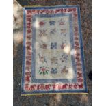 A Chinese rug, having hunting design to borders, 188 x 126cm.