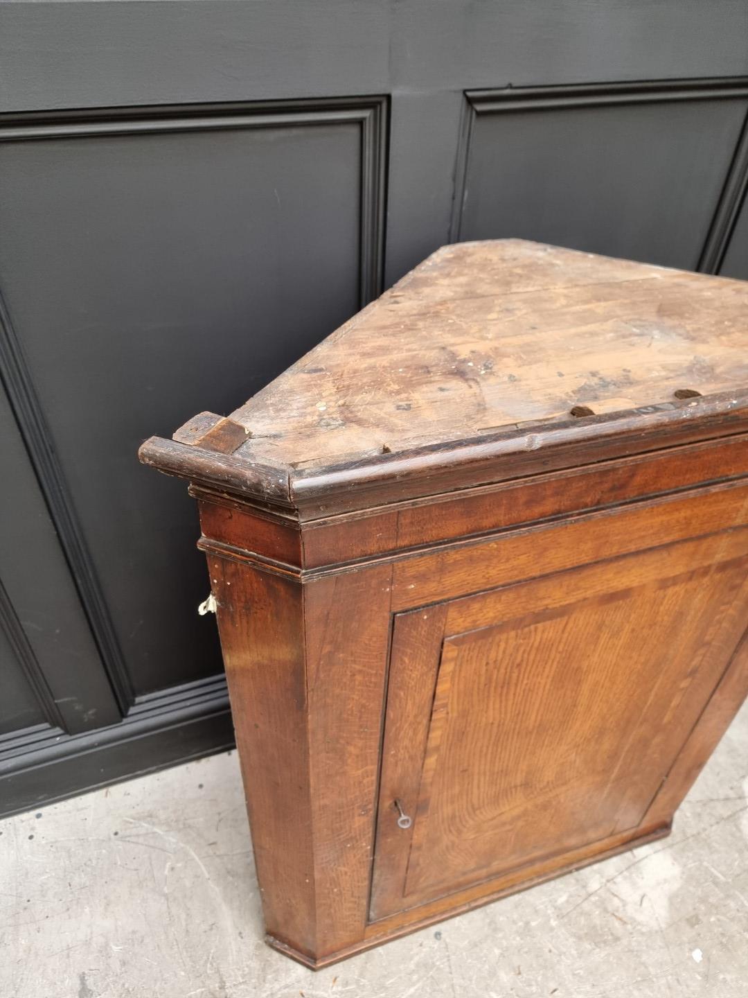 A George III oak and mahogany crossbanded hanging corner cupboard, 107.5cm high x 92cm wide; - Image 6 of 8