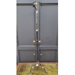 An Art and Crafts iron and copper adjustable standard lamp, (converted).