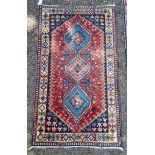 A small Persian rug, having three central medallions, with floral and geometric borders, 142 x 81cm.