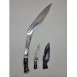 A very large kukri, length of blade 58.5cm; together with another Indian dagger and sheath. (2)