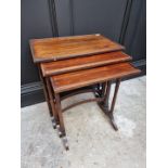 A nest of three rosewood occasional tables, largest 51.5cm wide.