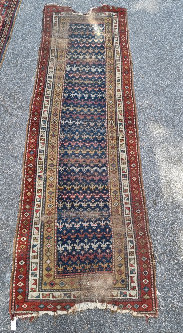 A Persian runner, having repeated central field, with geometric borders, 297 x 98cm.