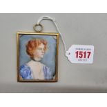 English School, circa 1900, bust length portrait miniature of a young lady with auburn hair, on