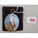 English School, 18th century, bust length portrait miniature of a gentleman holding a book, on