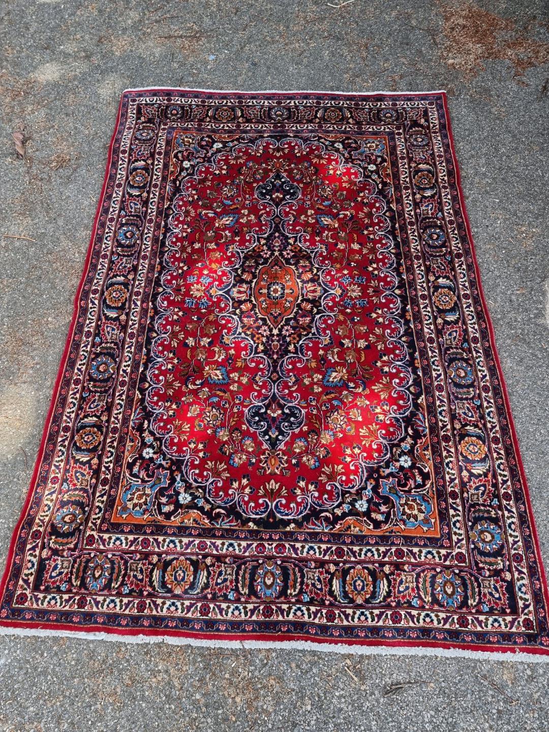 A Persian carpet, having floral central medallion, with floral cartouches to each corner, 293 x