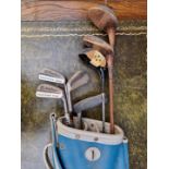 A vintage bag of eight old golf clubs.