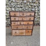 An old collectors chest, having fourteen drawers, 58cm wide x 19cm deep.