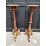 A large pair of Victorian cast iron tripod pedestals, with griffin feet, 122cm high.