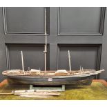 A painted wood model of the Cutty Sark, 97cm long, with various accompanying related items.