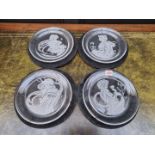 A set of four limited edition etched glass plates, each signed, 23cm diameter.