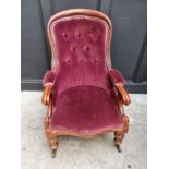A Victorian mahogany and button upholstered open arm occasional chair.