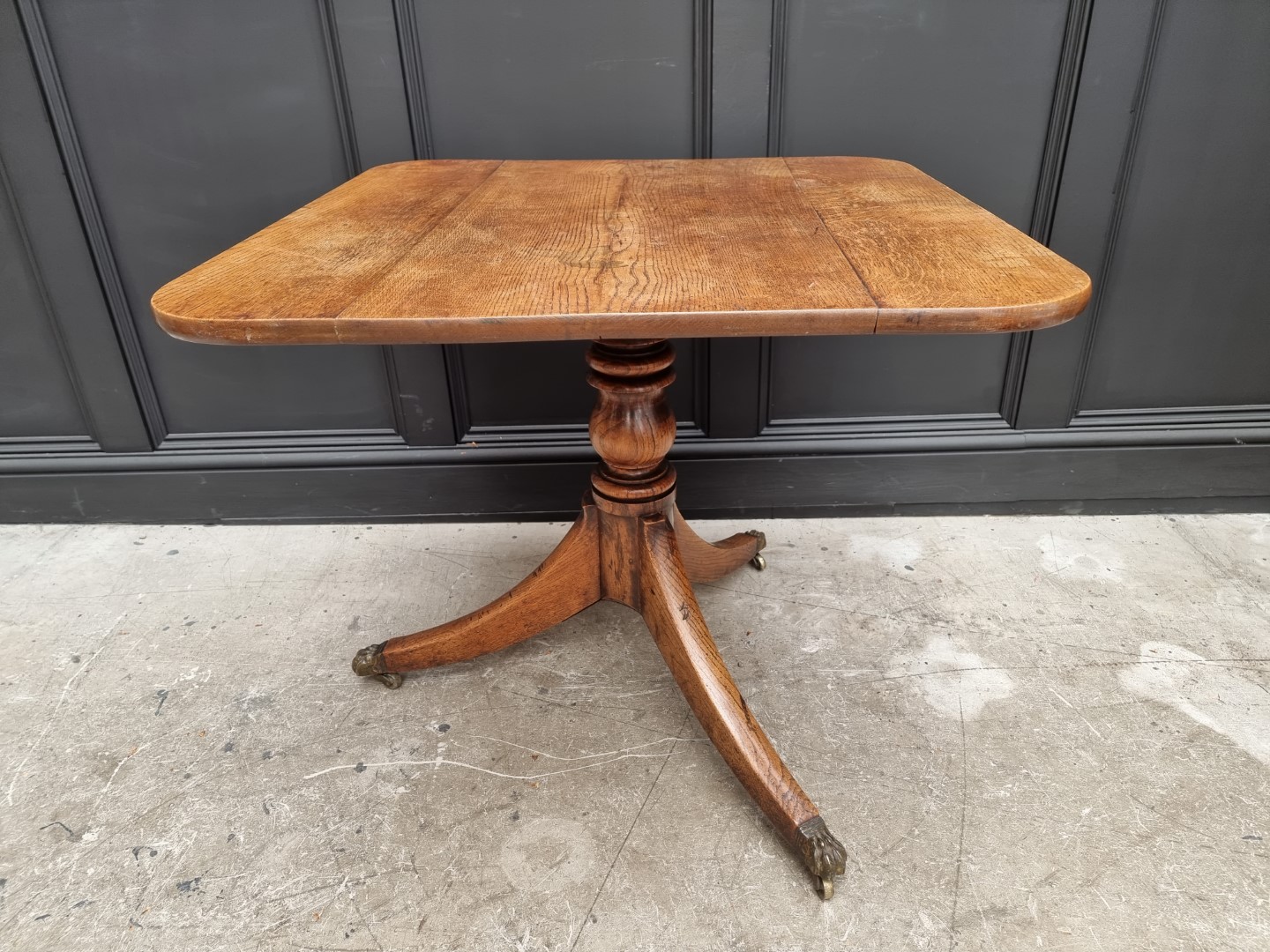 A 19th century oak tilt top tripod table, 81cm wide.
