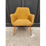 A mid-century upholstered armchair.