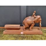 A Burmese teak elephant and log figure group, with bone tusks, 56cm wide.