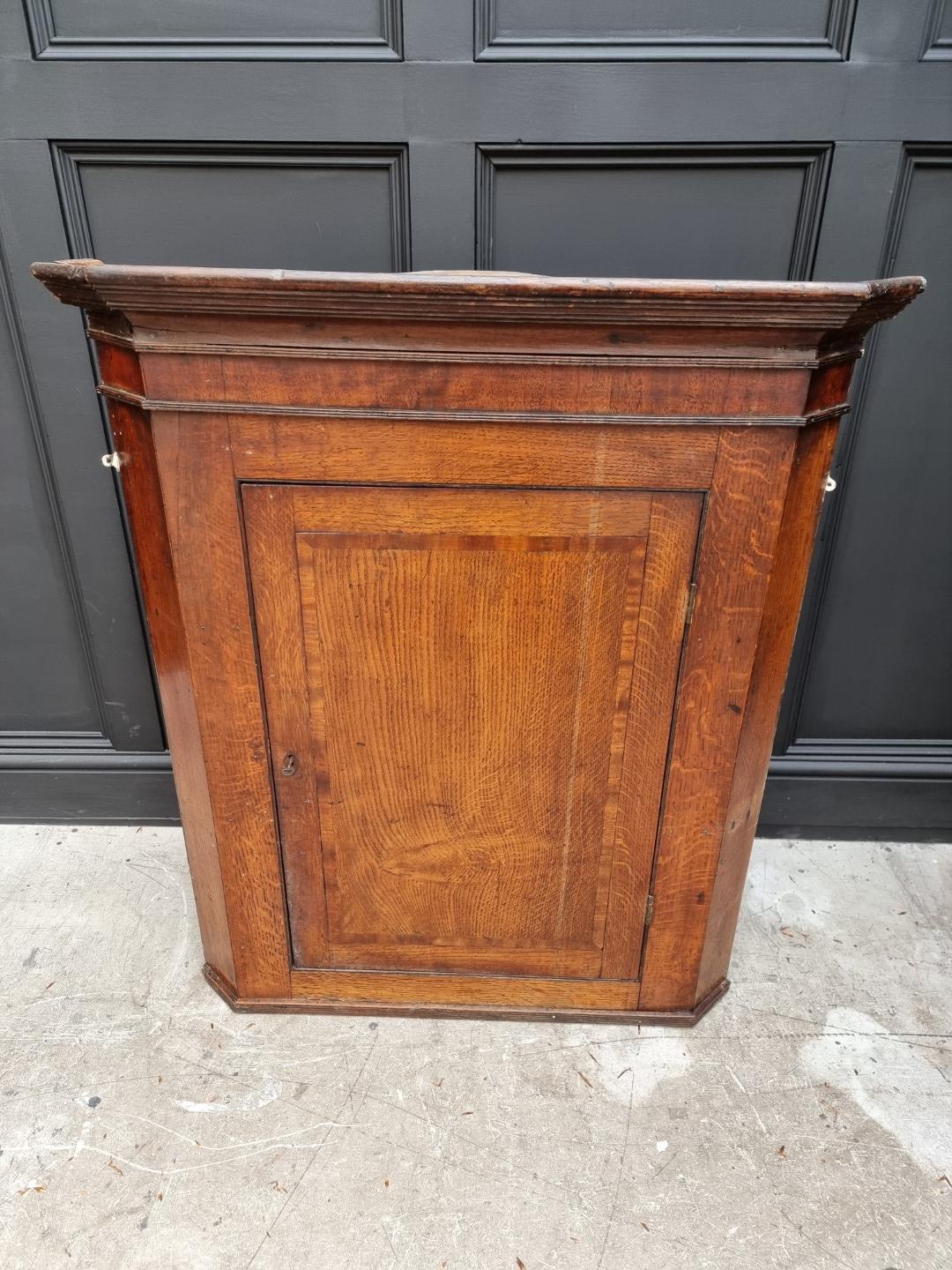 A George III oak and mahogany crossbanded hanging corner cupboard, 107.5cm high x 92cm wide; - Image 4 of 8