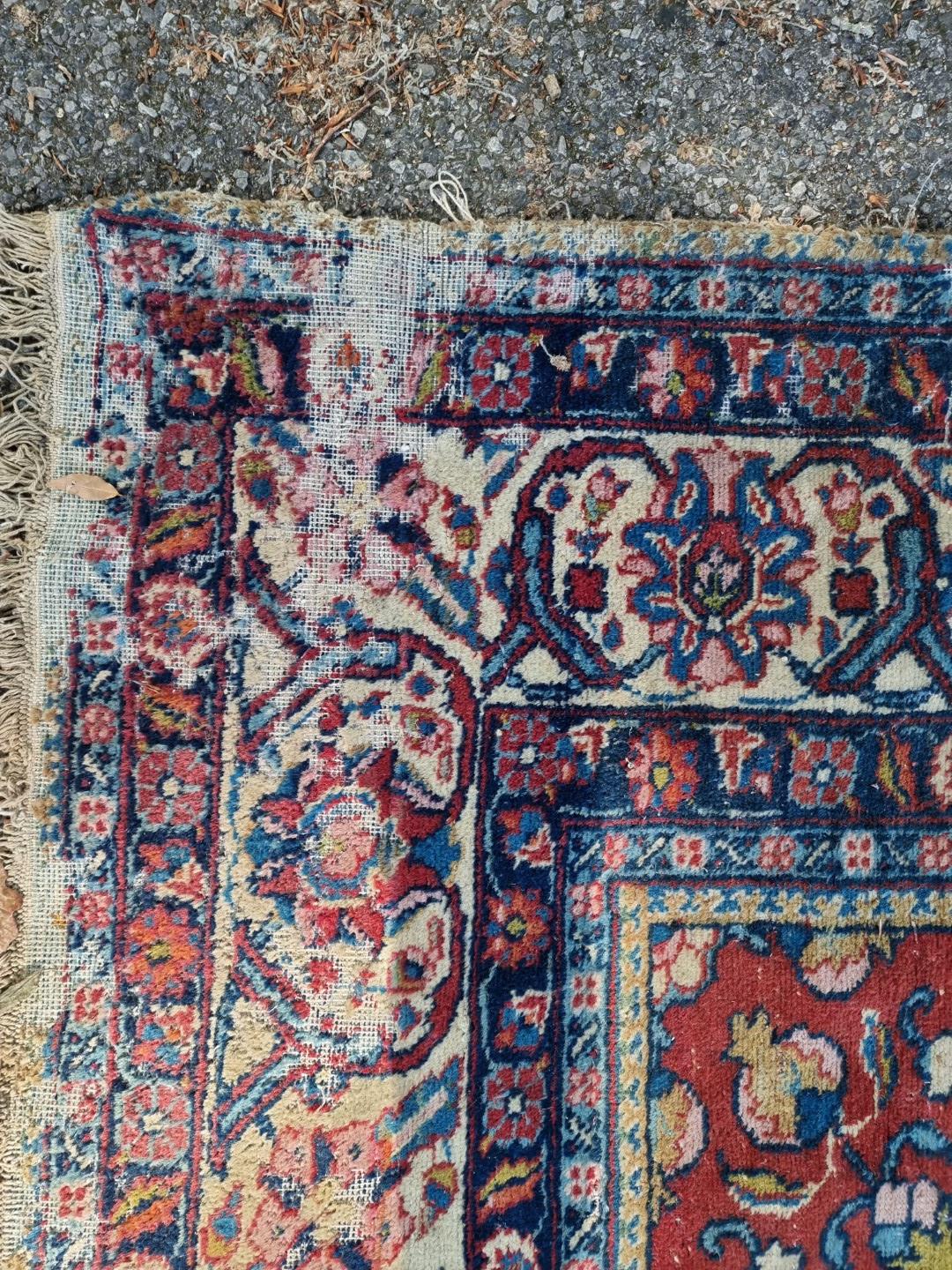 A Persian carpet, having central floral medallions, with floral cartouches to each corner of central - Image 9 of 10