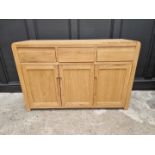 A contemporary pale oak side cabinet, 130cm wide.