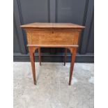 An unusual early 20th century oak writing table, by Asprey, the hinged top revealing a rising
