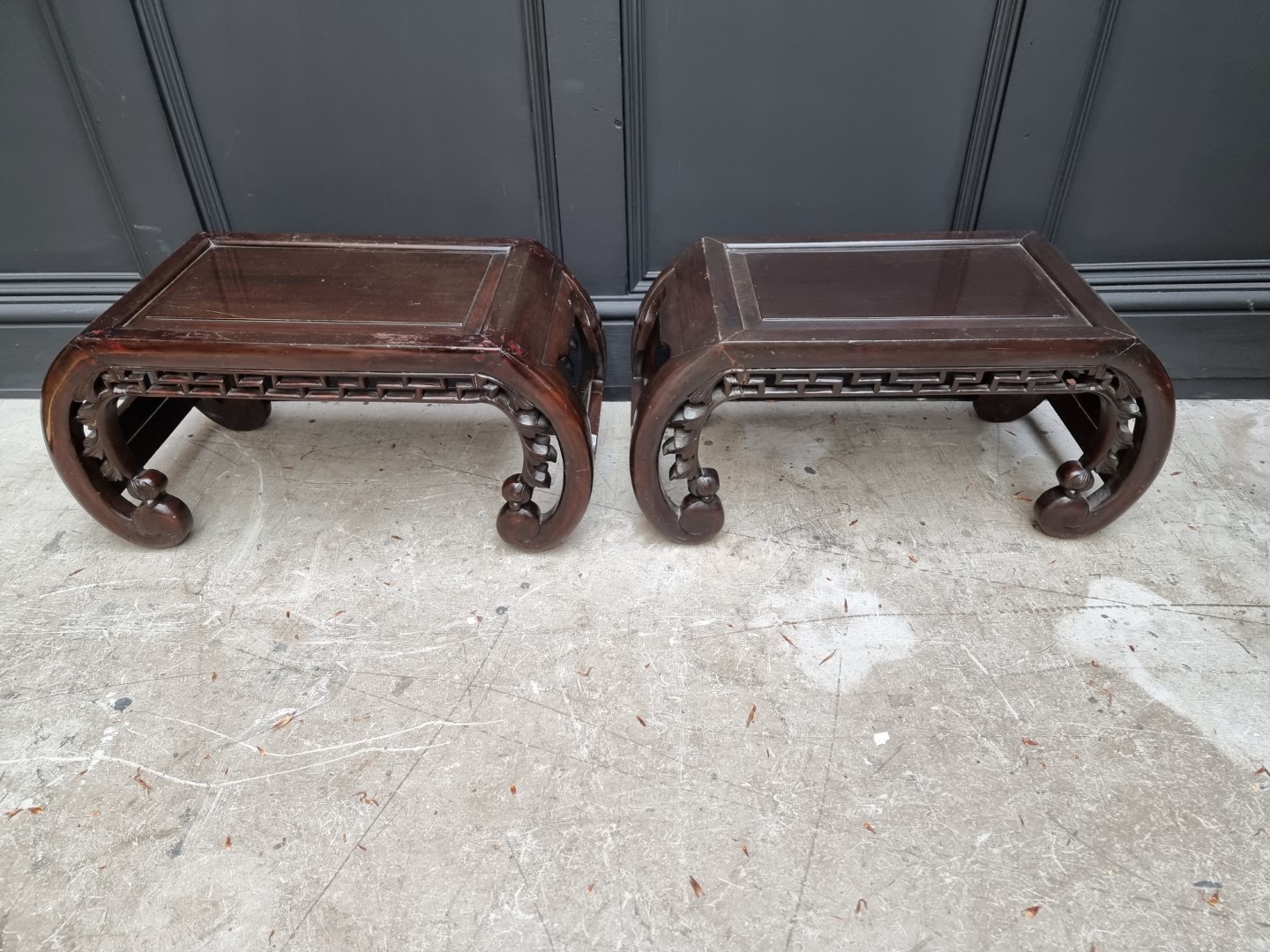 A pair of Chinese carved and stained wood opium tables, 64cm wide.