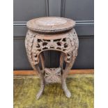 A Chinese carved hardwood and marble inset jardiniere stand, 61.5cm high.