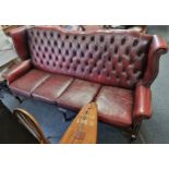 A large Queen Anne style buttoned leather settee, 213cm wide.